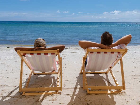 couple relaxing on a beach, professional management for rented flat